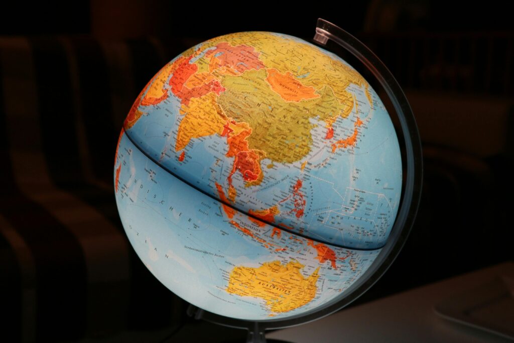 A vibrant illuminated globe showcasing Earth's continents in a dark setting, ideal for educational and decor purposes.