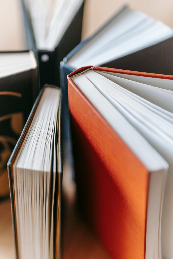 Stack of hardcover books with colorful covers in soft focus. Ideal for educational content.